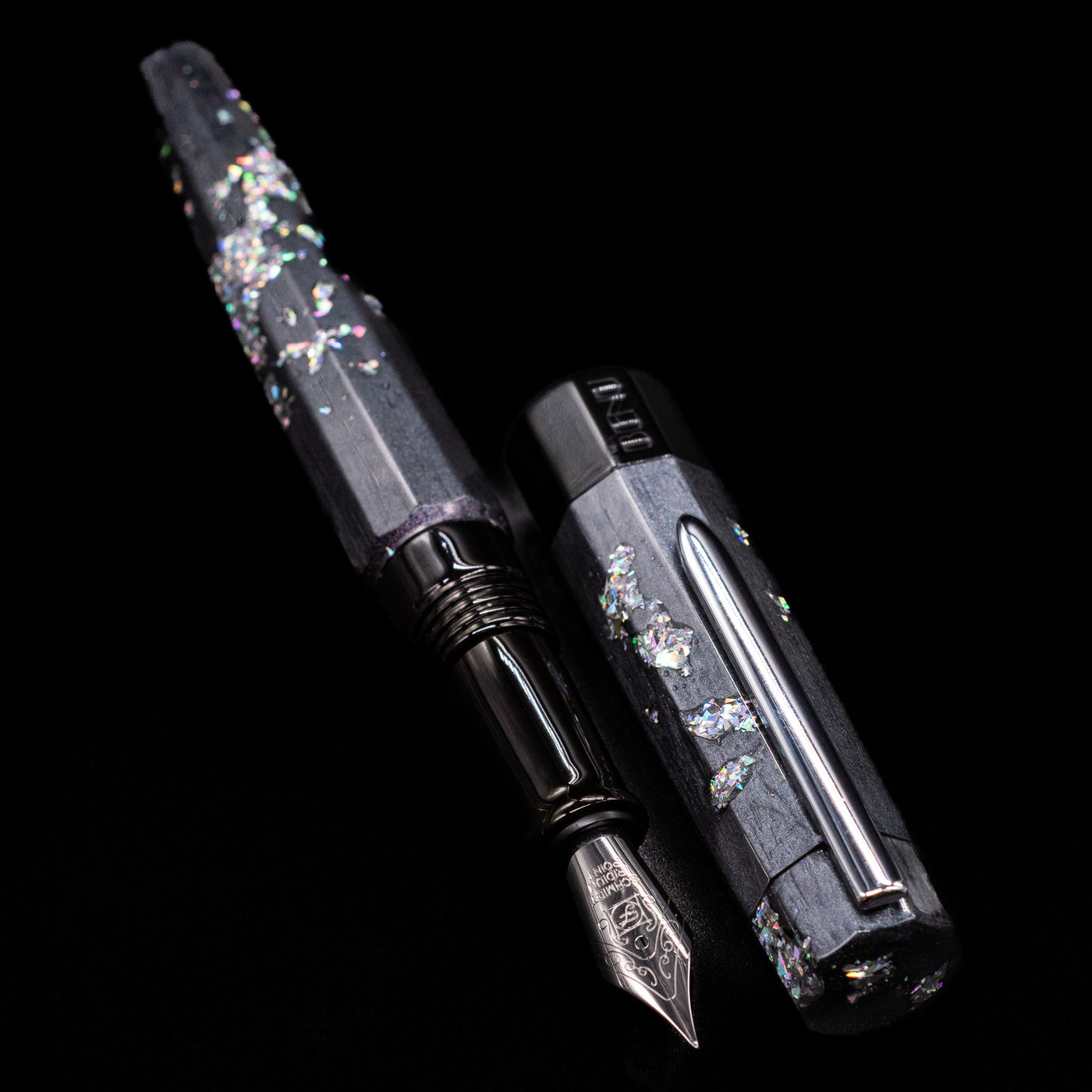 A full view of the BENU Euphoria Caviar Fountain Pen uncapped, with its cap laying next to the pen. 