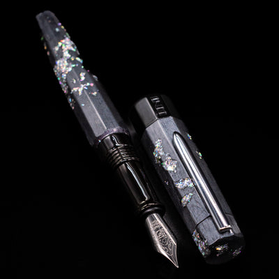 A full view of the BENU Euphoria Caviar Fountain Pen uncapped, with its cap laying next to the pen. 