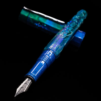 BENU Euphoria White Stag Fountain Pen laying across its own cap, crossed, with a focus on the nib.