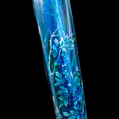 A zoomed in shot showcasing the leaves and foliage details on the BENU Euphoria White Stag Fountain Pen.