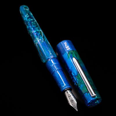 A full view of the BENU Euphoria White Stag Fountain Pen uncapped, with its cap laying next to the pen. 