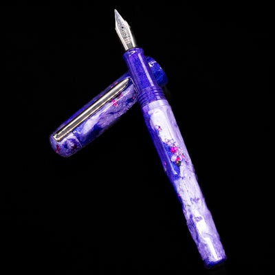 BENU Talisman Limited Edition Fountain Pen - Lavender laying on top of its cap in a crossed position showing full view of the entire uncapped pen.