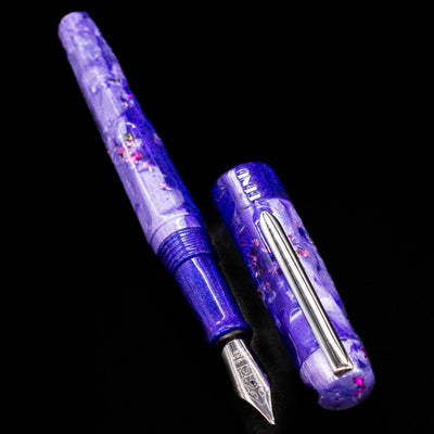  A full view of the BENU Talisman Limited Edition Fountain Pen - Lavender uncapped, with its cap laying next to the pen. 