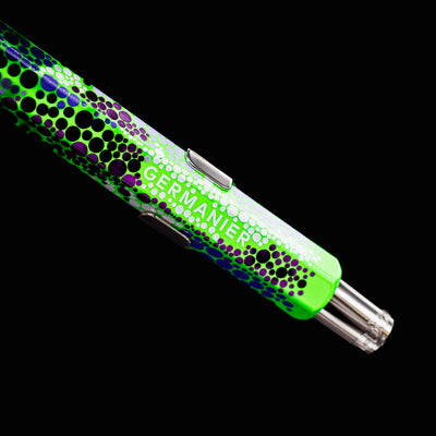 Close-up of the back end of the Caran d’Ache 849 Special Edition Germanier Fluo Green ballpoint pen, focusing on the silver push-button mechanism and the crisp transition to the fluorescent green body.