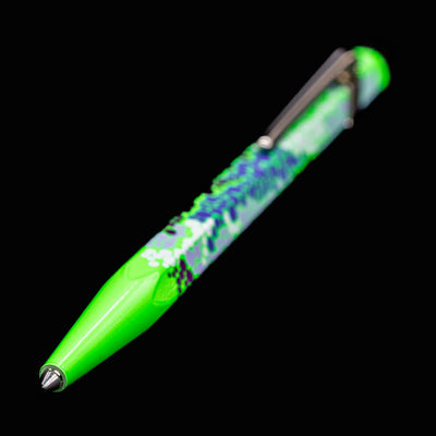 Full view of the Caran d’Ache 849 Special Edition Germanier Fluo Green ballpoint pen with the writing tip extended, highlighting the bright neon green finish, hexagonal shape, and silver clip.