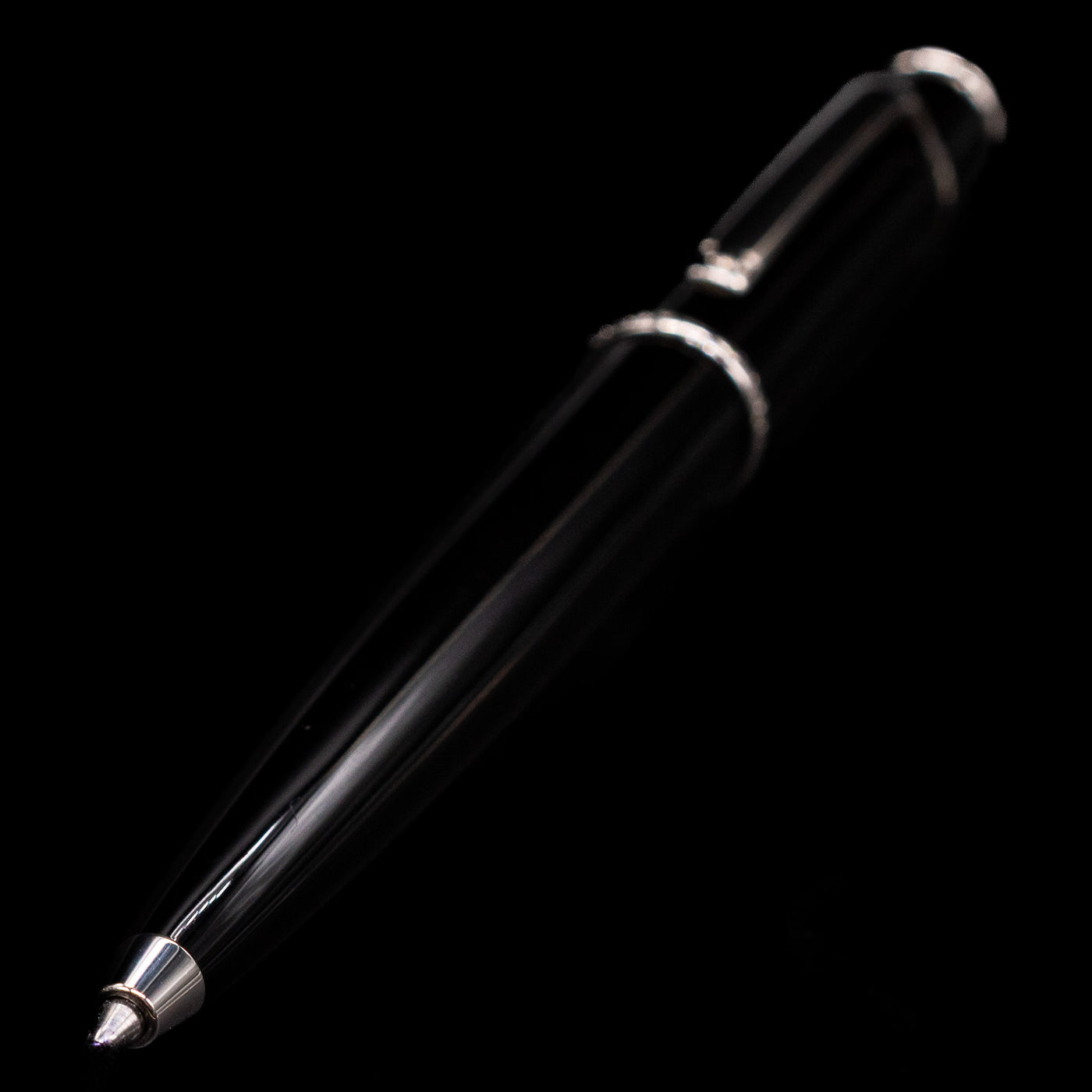 A full view of the Cartier Diabolo Black & Platinum Ballpoint Pen - Preowned with a focus on the activated tip.