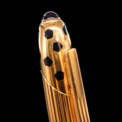 A macro shot of the top of the Cartier Panthere Black Lacquer Ballpoint Pen - Preowned to showcase the black detailing. 