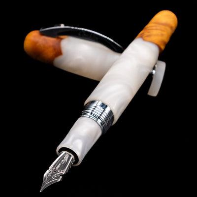 Conklin 1898 Fountain Pen - Spectra Fusion White laying across its own cap, crossed, with a focus on the nib.