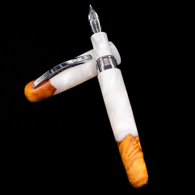 Conklin 1898 Fountain Pen - Spectra Fusion White laying on top of its cap in a crossed position showing full view of the entire uncapped pen.