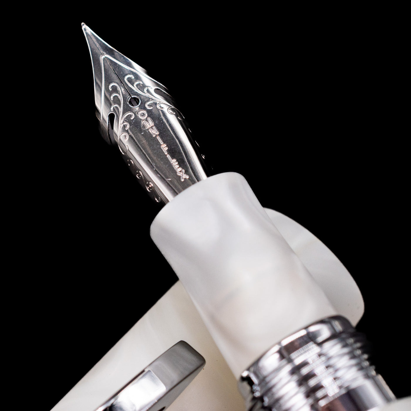 A macro shot of the nib with its intricate detailing and logo engraving for the Conklin 1898 Fountain Pen - Spectra Fusion White.