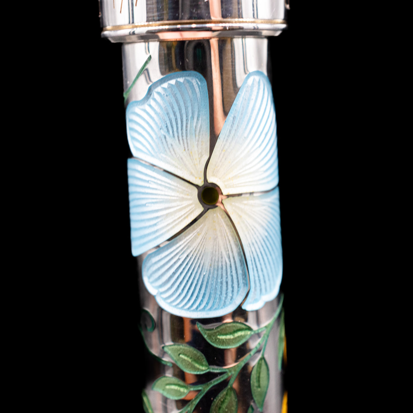 A macro shot of one of the blue flowers on the body of the David Oscarson Carl Linnaeus Fountain Pen - White.