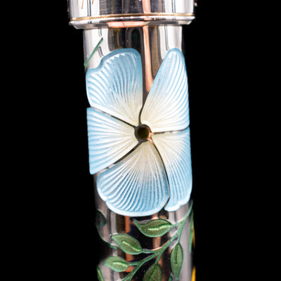 A macro shot of one of the blue flowers on the body of the David Oscarson Carl Linnaeus Fountain Pen - White.