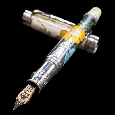 David Oscarson Carl Linnaeus Fountain Pen - White laying across its own cap, crossed, with a focus on the nib.