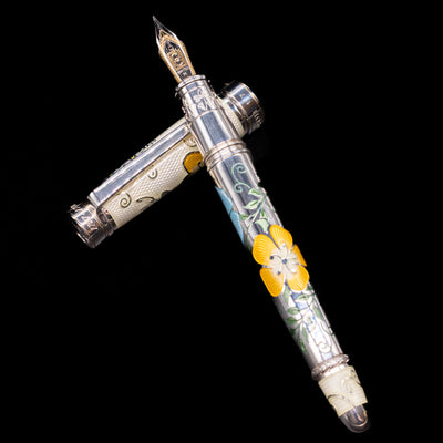 David Oscarson Carl Linnaeus Fountain Pen - White laying on top of its cap in a crossed position showing full view of the entire uncapped pen.