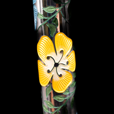 A macro shot of one of the yellow flowers on the body of the David Oscarson Carl Linnaeus Fountain Pen - White.