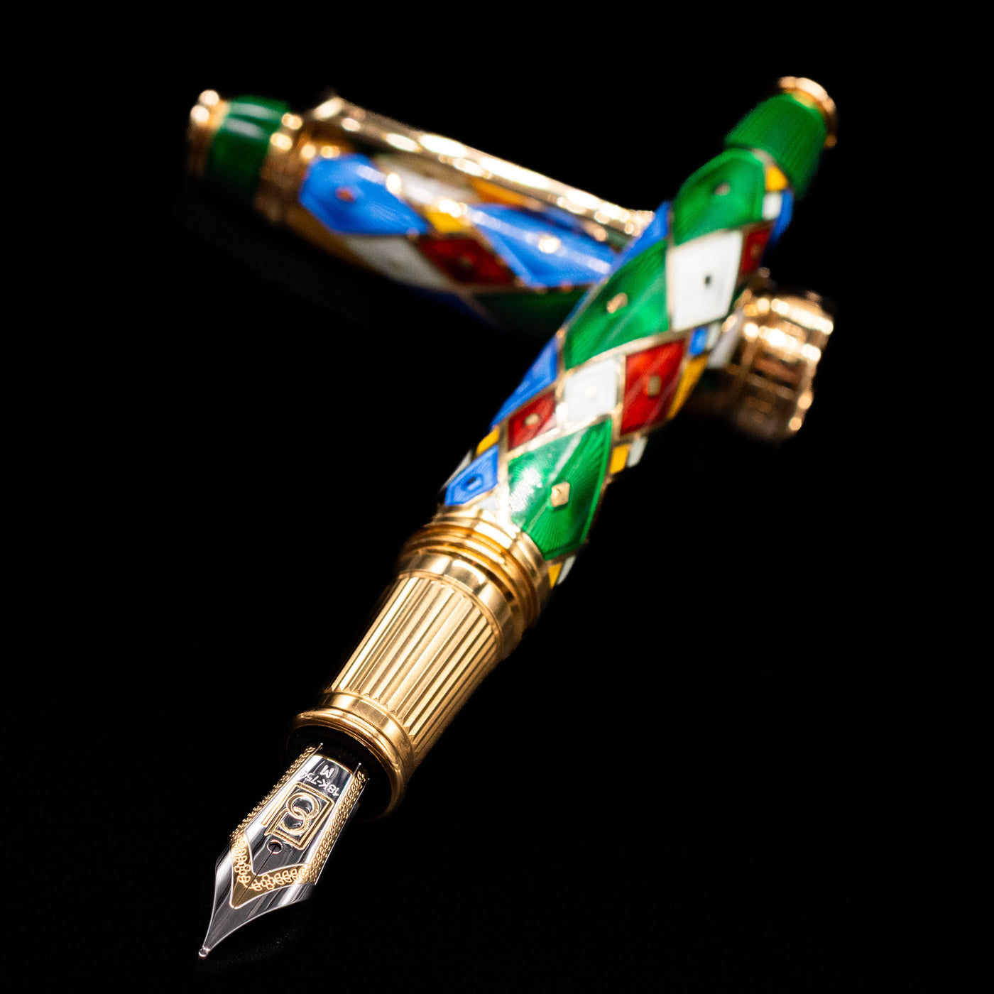 David Oscarson Harlequin Fountain Pen - Emerald Green laying across its own cap, crossed, with a focus on the nib.