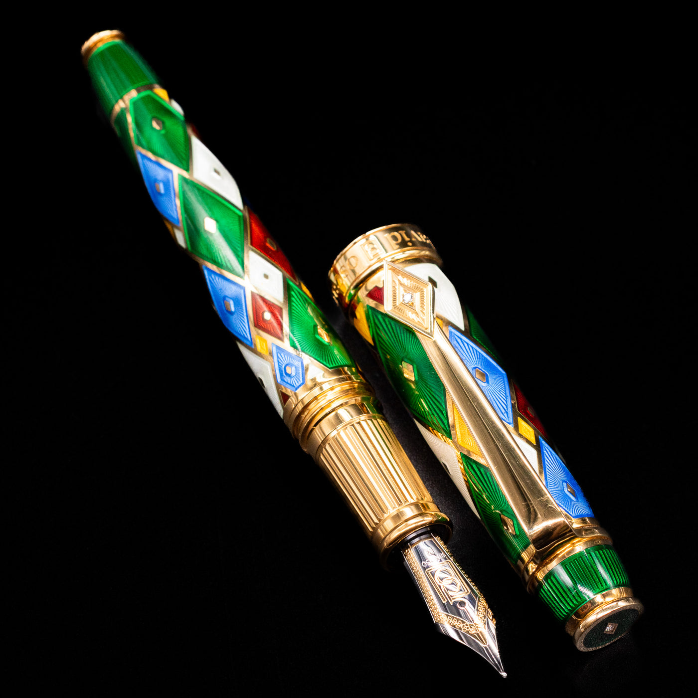 A full view of the David Oscarson Harlequin Fountain Pen - Emerald Green uncapped, with its cap laying next to the pen. 