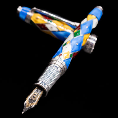 David Oscarson Harlequin Fountain Pen - Sapphire Blue laying across its own cap, crossed, with a focus on the nib.