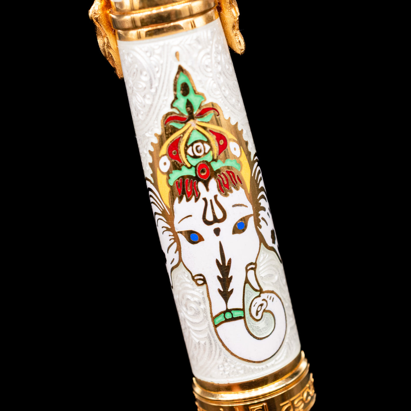 A macro shot of the back of the cap on the David Oscarson Lord Ganesha Fountain Pen - White wih Lord Ganesha depicted in bright colors against a white textured background.