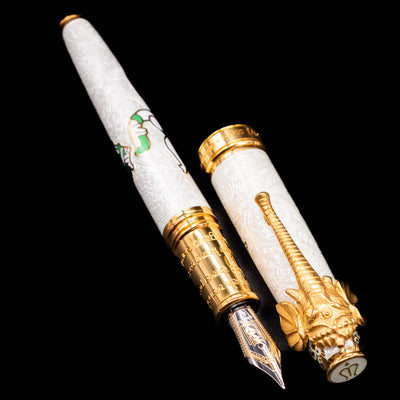 A full view of the David Oscarson Lord Ganesha Fountain Pen - White uncapped, with its cap laying next to the pen. 
