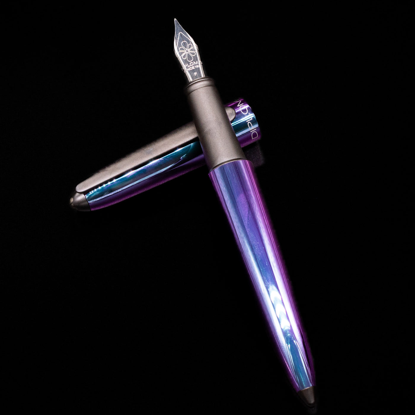 Diplomat Aero Fountain Pen - Funky laying on top of its cap in a crossed position showing full view of the entire uncapped pen.