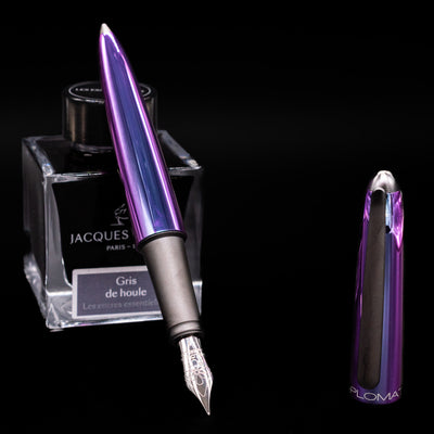 Diplomat Aero Fountain Pen - Funky leaning on an ink bottle uncapped showcasing the detailing on the nib.