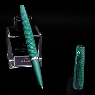 Diplomat Viper Fountain Pen - Green leaning on an ink bottle uncapped showcasing the detailing on the nib.