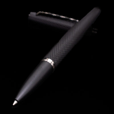Diplomat Viper Rollerball Pen - Black laying across its own cap, crossed, with a focus on the tip.