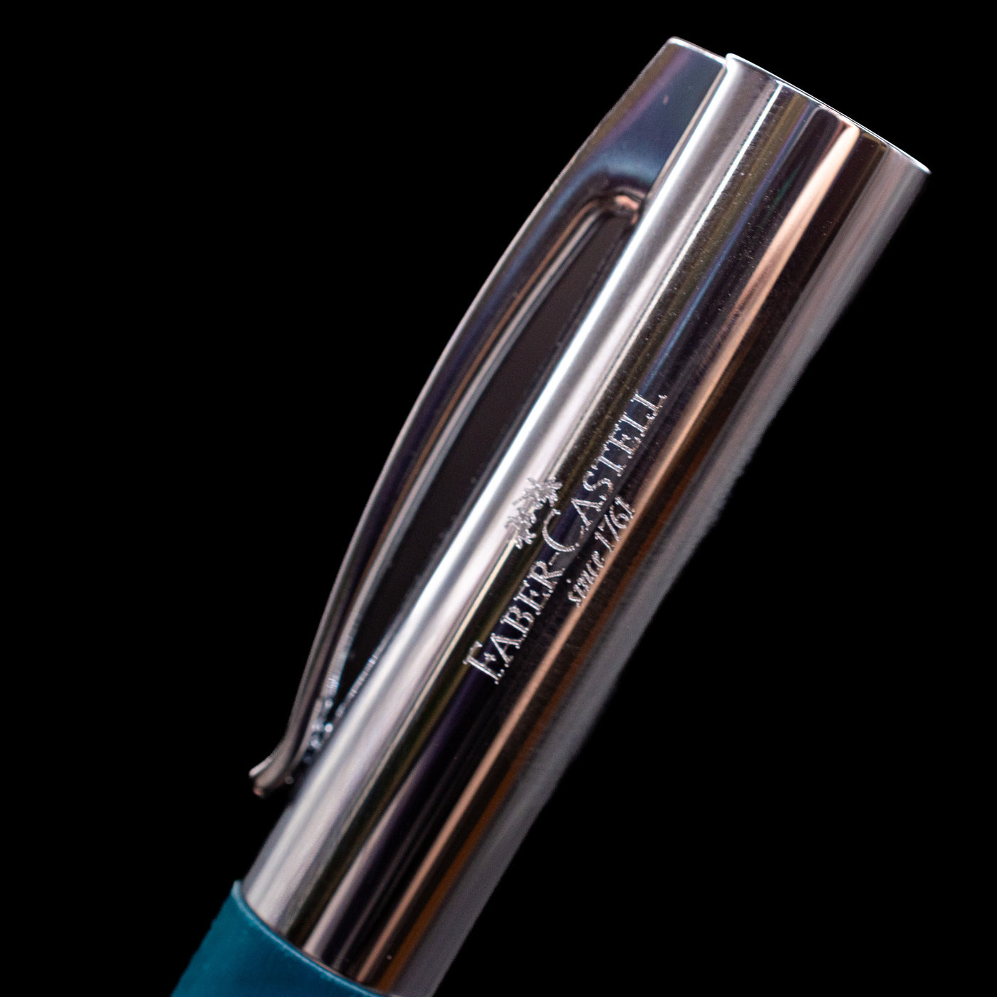 A close-up shot of the logo on the side of the cap for the Faber-Castell Ambition Fountain Pen - Soft Teal (Limited Edition).