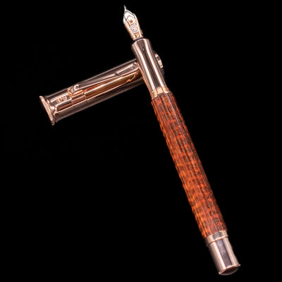 Graf von Faber-Castell Classic Limited Edition fountain pen, uncapped, laid across its cap, showcasing the snakewood barrel pattern and rose gold accents.