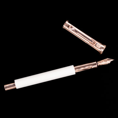 An overhead view of the Graf von Faber-Castell Guilloche Fountain Pen - Champagne Blush uncapped.