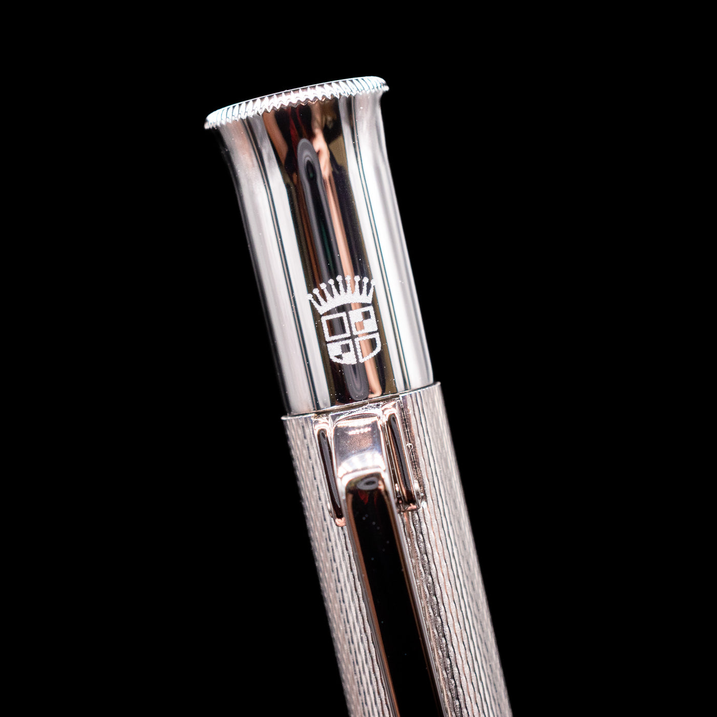 A macro shot of the logo on the cap on the Graf von Faber-Castell Guilloche Mechanical Pencil - Barley Rhodium.