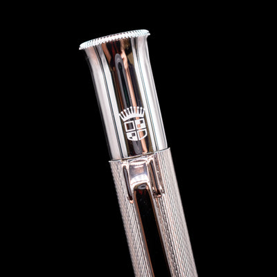 A macro shot of the logo on the cap on the Graf von Faber-Castell Guilloche Mechanical Pencil - Barley Rhodium.