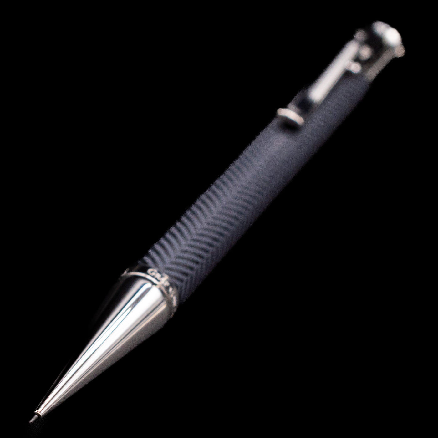 A full view of the Graf von Faber-Castell Guilloche Mechanical Pencil - Cisele Anthracite with a focus on its tip.