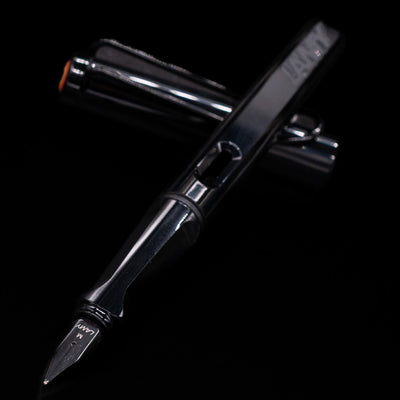LAMY Safari Multi Fountain Pen and cap crossed with the nib in sharp focus, highlighting the clean black body and metal nib.