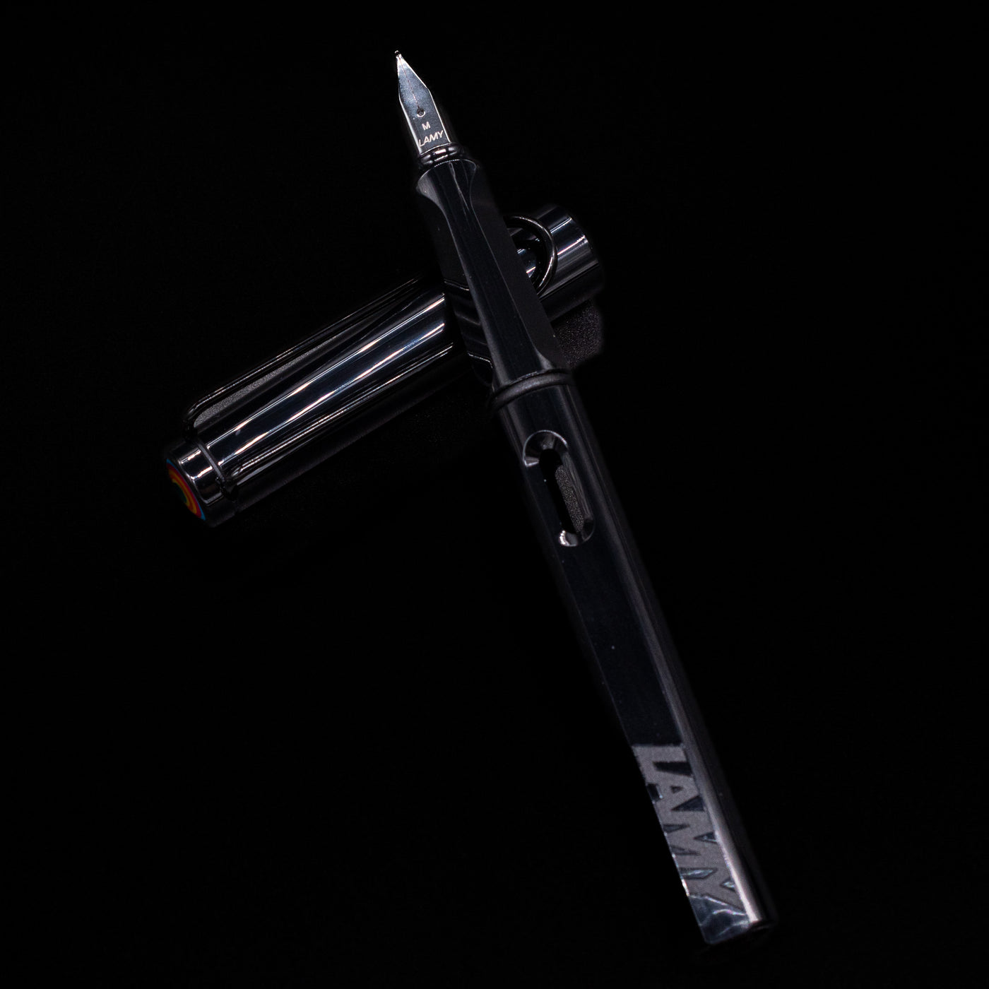 Uncapped black Safari Multi laid across its cap, showcasing the ergonomic grip section and minimalist design.