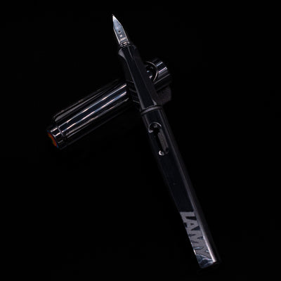Uncapped black Safari Multi laid across its cap, showcasing the ergonomic grip section and minimalist design.