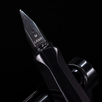 Detailed macro shot of the polished nib, showing engraved LAMY branding on the LAMY Safari Multi Fountain Pen in glossy black.