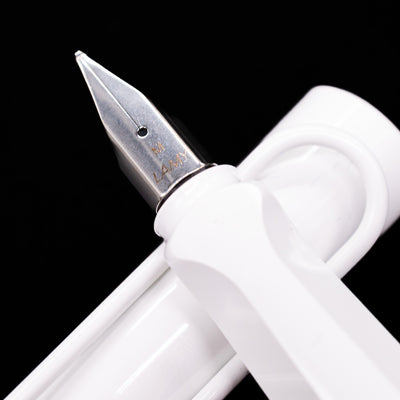 Detailed macro shot of the polished nib, showing engraved LAMY branding on the LAMY Safari Multi Fountain Pen in glossy white.
