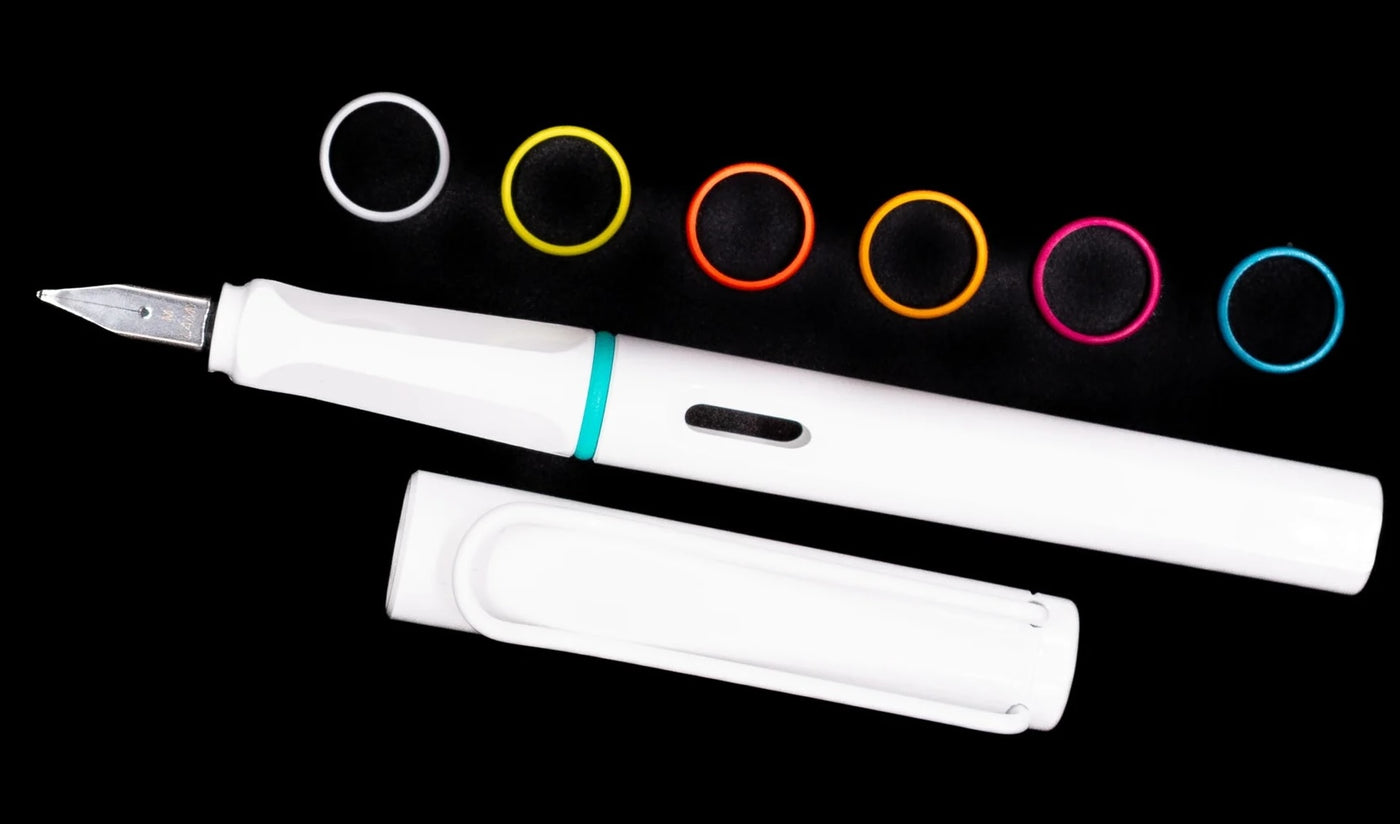 White fountain pen with ink cartridges on a black background