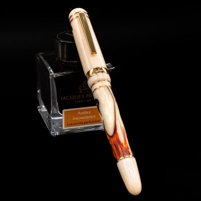 Laban 326 Fountain Pen - Desert Mirage capped, leaning against an ink bottle. 