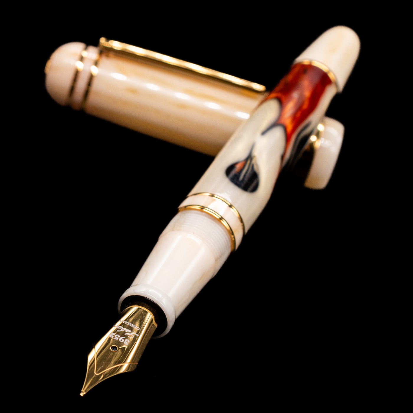 Laban 326 Fountain Pen - Desert Mirage laying across its own cap, crossed, with a focus on the nib.