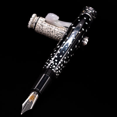 Loiminchay Snow with Jade Clip Fountain Pen laying across its own cap, crossed, with a focus on the nib.