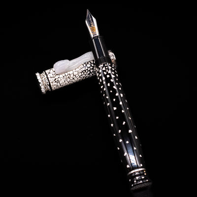 Loiminchay Snow with Jade Clip Fountain Pen laying on top of its cap in a crossed position showing full view of the entire uncapped pen.