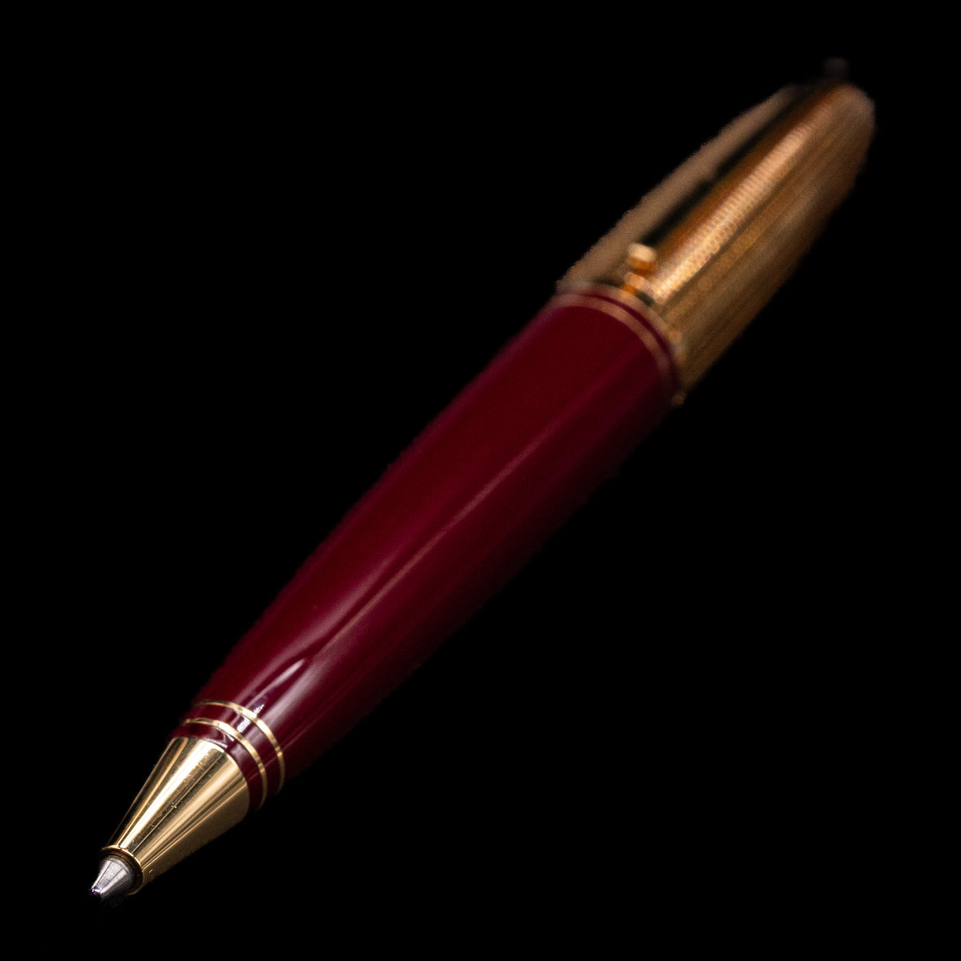 Full view of the Louis Vuitton Doc Lacquer Burgundy & Gold Ballpoint Pen - Preowned with a focus on the tip.