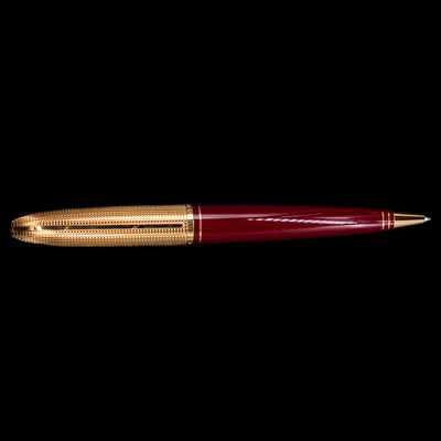 An overhead view of the Louis Vuitton Doc Lacquer Burgundy & Gold Ballpoint Pen - Preowned.