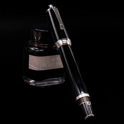 Montblanc Boheme Jumbo Large Fountain Pen - Preowned capped, leaning against an ink bottle. 