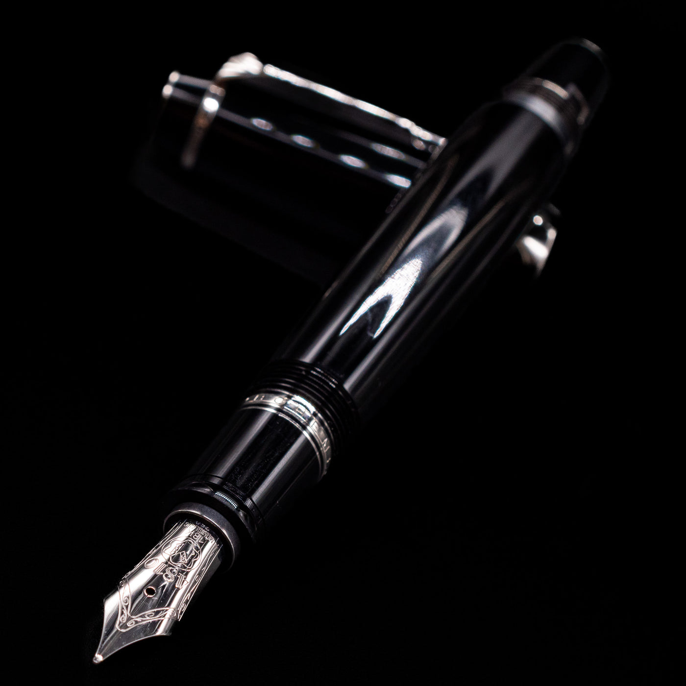Montblanc Boheme Jumbo Large Fountain Pen - Preowned laying across its own cap, crossed, with a focus on the nib.