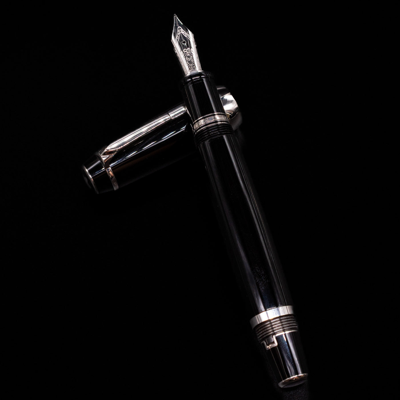 Montblanc Boheme Jumbo Large Fountain Pen - Preowned laying on top of its cap in a crossed position showing full view of the entire uncapped pen.