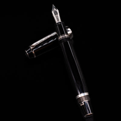 Montblanc Boheme Jumbo Large Fountain Pen - Preowned laying on top of its cap in a crossed position showing full view of the entire uncapped pen.